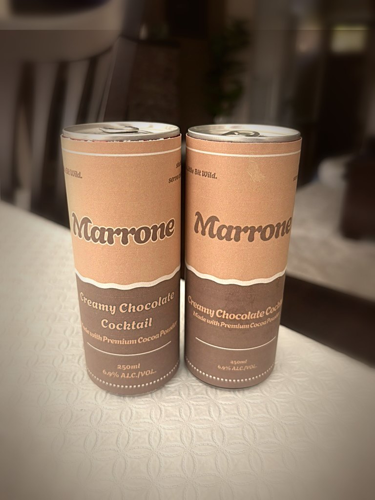 Two chilled cans of Marrone Creamy Chocolate Cocktail on a table